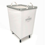 Corner Heavy-Duty Canvas Hamper w/Wheels, 24"W x 17.7"D, Natural White | Space-saving corner design holds 3 to 4 loads of laundry with a durable steel frame, smooth-rolling locking wheels