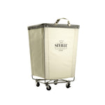 Corner Heavy-Duty Canvas Hamper w/Wheels, 24"W x 17.7"D, Natural White | Space-saving corner design holds 3 to 4 loads of laundry with a durable steel frame, smooth-rolling locking wheels
