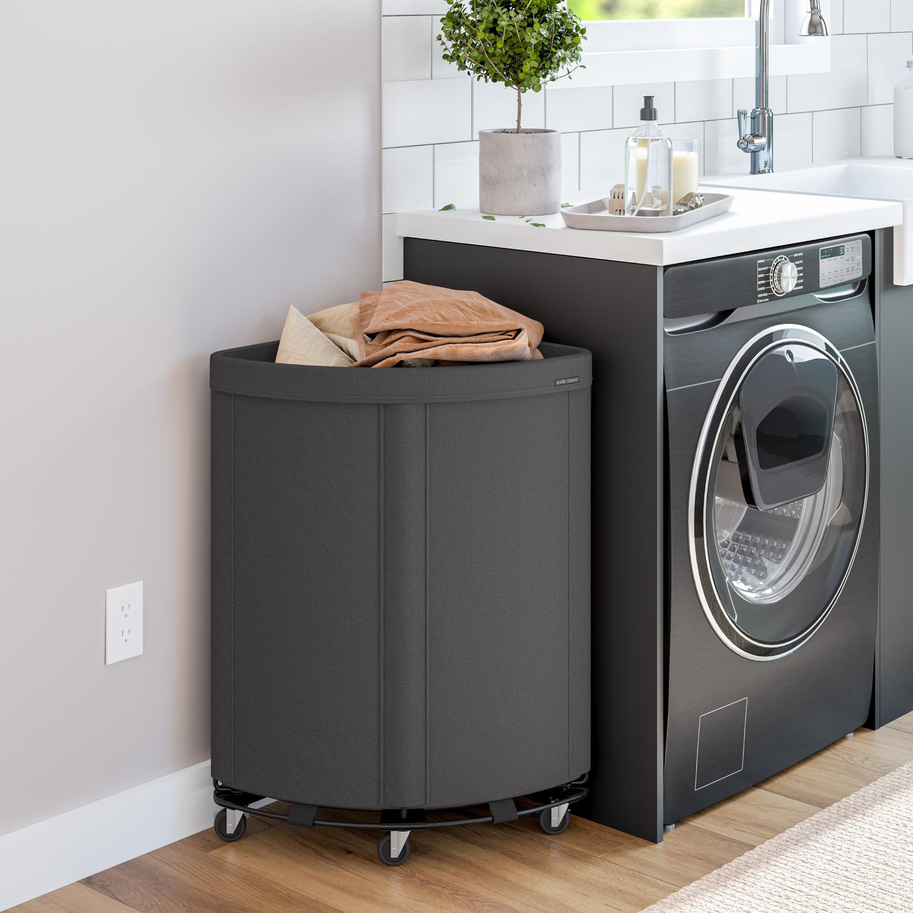 Corner Heavy-Duty Canvas Hamper w/Wheels, 24"W x 17.7"D, Natural White | Space-saving corner design holds 3 to 4 loads of laundry with a durable steel frame, smooth-rolling locking wheels