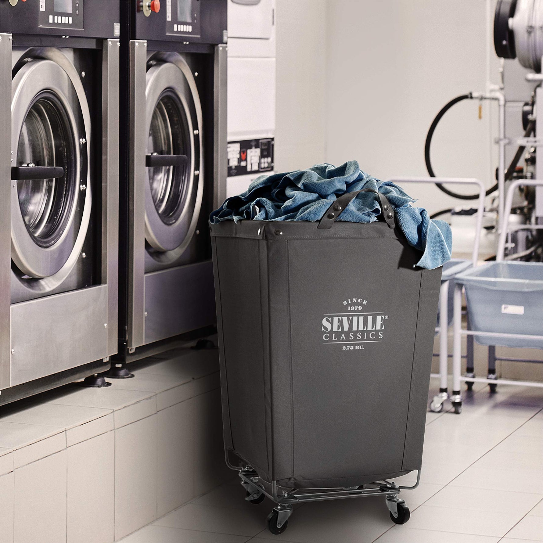 Corner Heavy-Duty Canvas Hamper w/Wheels, 24"W x 17.7"D, Natural White | Space-saving corner design holds 3 to 4 loads of laundry with a durable steel frame, smooth-rolling locking wheels