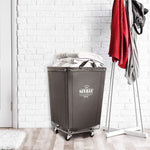 Corner Heavy-Duty Canvas Hamper w/Wheels, 24"W x 17.7"D, Natural White | Space-saving corner design holds 3 to 4 loads of laundry with a durable steel frame, smooth-rolling locking wheels